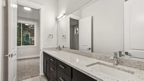 Upstairs bath between two bedrooms, dual sink vanity, slab quartz and separate water closet