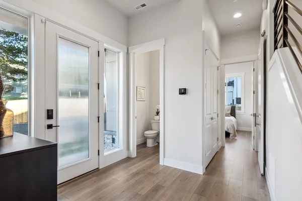 entryway of home with reeded glass door and powder room