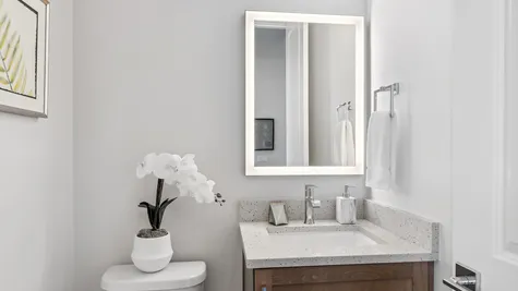 powder room with led backlit mirror