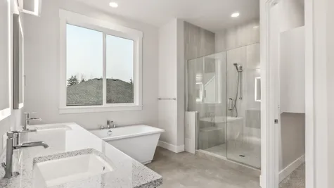 bathroom with tile floor, fully tiled walk-in shower, freestanding soaking tub