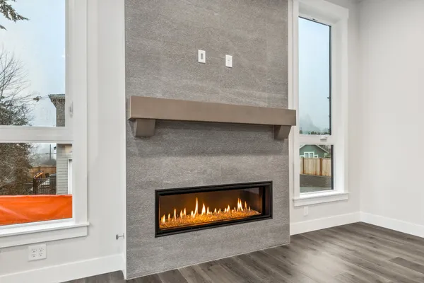 gas fireplace flanked by two windows