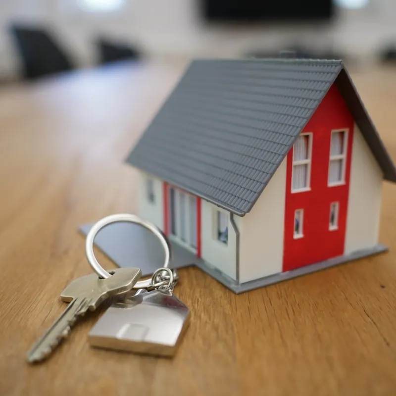 A mini home next to a set of keys