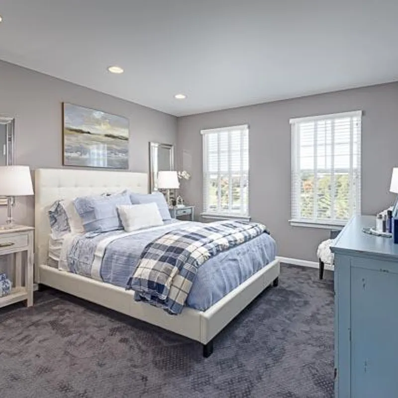 A fully carpeted bedroom accompanying a blog post about carpet by condo builder Robertson Homes in Michigan