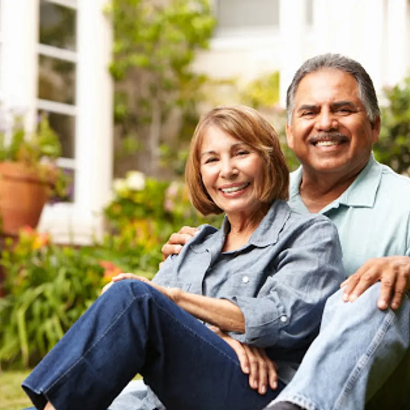 An older couple sitting outside representing the downsizing tips provided by Robertson Homes in Michigan