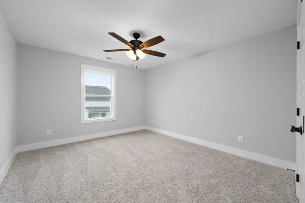 The Brayden bedroom with carpet, a ceiling fan, and a window on the back wall