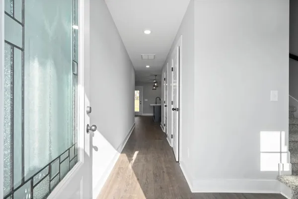 The Maui hallway with wood-look flooring leading from the front entry to the main living area