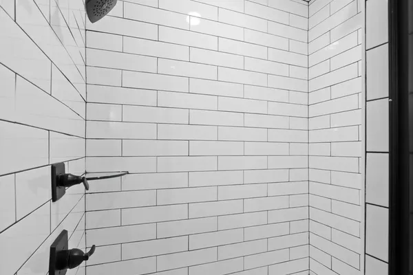 The Brayden bathroom shower with white subway tile, a built-in niche, and black fixtures
