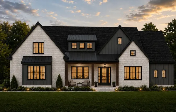 Front exterior of The Magnolia by Rockwood Homes, a 1.5-story white farmhouse-style home with black trim and steep gables.