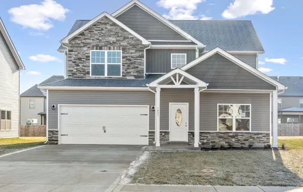 Two-story gray home with stone accents and a two-car garage at Cherry Fields by Rockwood Homes in Clarksville, TN.