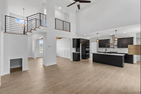 The Smokey kitchen viewed from the living room, with a black island and a two-story ceiling