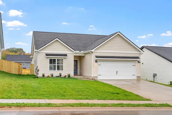 Front exterior of The Cumberland by Rockwood Homes, a single-story home with cream siding and a two-car garage.