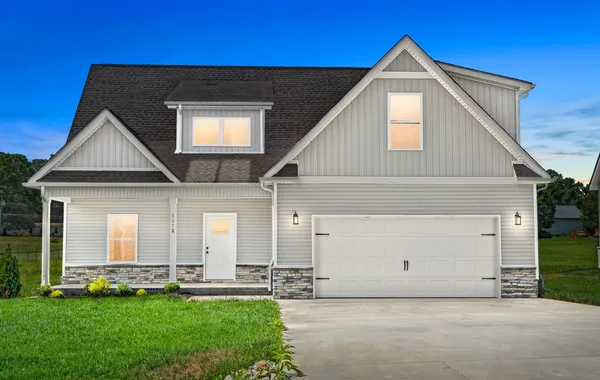 Front exterior of The Brookhaven by Rockwood Homes, a two-story home with gray siding, a covered porch, and a two-car garage.
