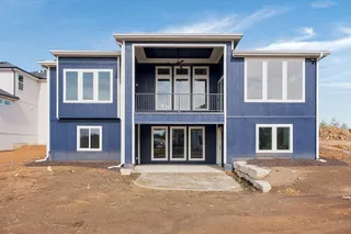 Two-story exterior with blue vertical siding and white trim