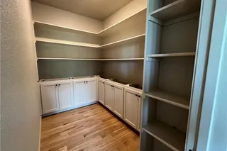 Walk In Pantry with Hardwood Floors, tons of shelf space, Upgraded Lower Level Cabinets and stack shelves to help with organization. Home Under  Construction. OCTOBER 2026 COMPLETION, PHOTO IS OF ACTUAL HOME.