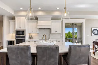 Premium quartz countertops and elegant cabinetry define this refined culinary space. PHOTO IS OF ACTUAL HOME.