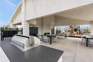 Sheltered outdoor seating areas gather around a central double-sided fireplace and built-in barbecue station.