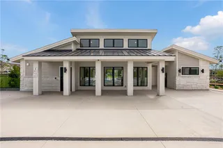 Clean lines and stone accents define this modern community building with its covered concrete entry.