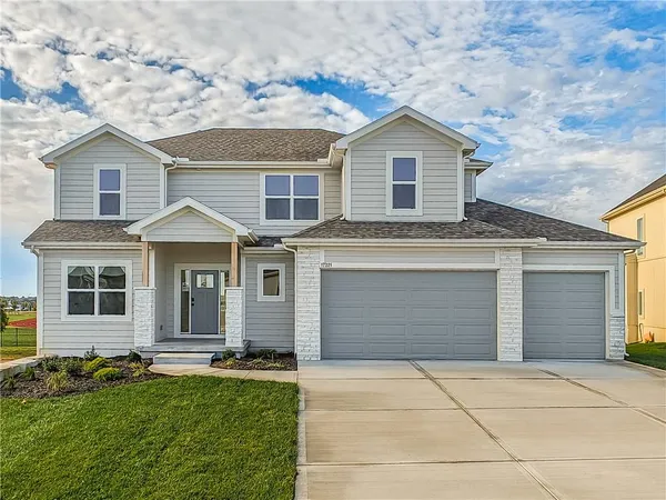 Clean lines and a spacious driveway define this modern two-story home with integrated garage.
