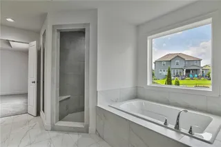 Walk in shower and soaker tub. Picture is of the actual home.