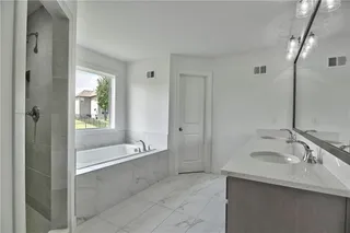 Master Bath with Double Vanity, Walk in Shower & Soaker Tub. Picture is of the actual home.