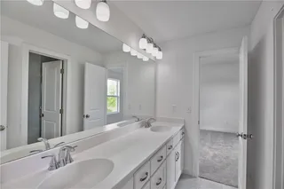 Hollywood bath shared by bedrooms #3 and #4, double vanity. Picture is of the actual home.