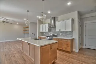 PHOTOS ARE OF ACTUAL HOME. View of Kitchen with upgraded Kitchen Tile Backsplash, Soft Close Drawers, Quartz Counter Tops, Super Single Stainless Steel Sink Apron Sink with SS Appliances, Walk in Pantry and Gas Stove.