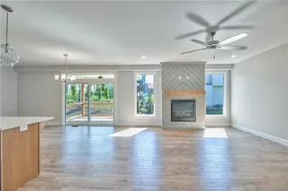 PHOTOS ARE OF ACTUAL HOME. View of Great Room with Gas Fireplace with Oversized Sliding Glass Doors to Covered Deck.