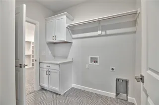 PHOTOS ARE OF ACTUAL HOME. Laundry Room features built-ins, quartz counter top and is accessible to Master Closet