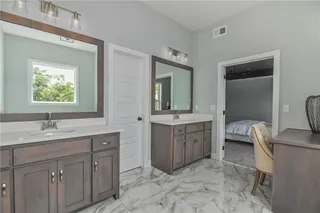 PICTURE IS OF THE ACTUAL HOME. MASTER BATHROOM FEATURES DOUBLE VANITIES, MAKEUP DRESSER, AND A FREE STANDING TUB.