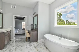 PICTURE IS OF THE ACTUAL HOME. MASTER BATHROOM FEATURES DOUBLE VANITIES, MAKEUP COUNTER, AND A FREE STANDING TUB.