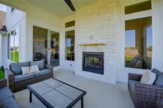 PHOTOS ARE OF A PREVIOUS MODEL AND MAY FEATURE UPGRADES. NOT THE ACTUAL HOME. BUYERS CAN STILL MAKE SELECTIONS! WONDERFUL OUTDOOR LIVING SPACE IN THIS COVERED PORCH WITH FIREPLACE AND CEILING FAN.