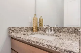  HALF BATH OFF OF THE KITCHEN WITH GRANITE COUNTER.  PHOTOS ARE OF THE ACTUAL HOME.