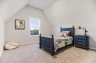 BEDROOM 4 WITH VAULTED CEILING.  PHOTOS ARE OF THE ACTUAL HOME.