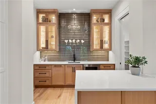 White Oak cabinetry accentuates this brilliantly designed Bar.  Completely open to your kitchen for additional counter space.