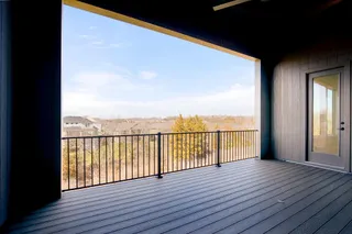 PICTURE IS OF ACTUAL HOME. What a view overlooking the neighborhood! Dining Room with Wall of Windows and Oversized Slider that leads out to composite deck.