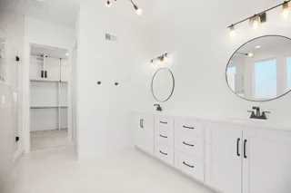 PICTURE IS OF ACTUAL HOME. Primary En Suite - Who needs to go to the Spa? Spacious Soaker Tub with Shower Wand, Rain Glass for Privacy, Walk in Shower with Double Shower Heads, So much Vanity Space and Walk in Closet with Pull Downs to utilized ALL the closet space.