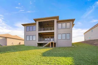 PICTURE IS OF ACTUAL HOME. Rear Elevation of a Stunning home nestled in a location that over looks green space and a view of the neighborhood. 