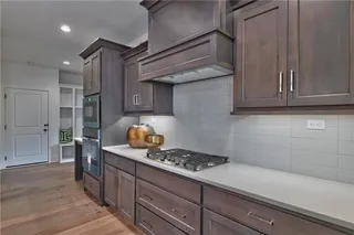 Gourmet Kitchen with Quartz Counter Tops, Stainless Steel Appliances, Custom Stain and Super Single Stainless Steel Sink. Picture is of Actual Home.