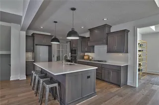 Gourmet Kitchen with Quartz Counter Tops, Stainless Steel Appliances, Custom Stain and Super Single Stainless Steel Sink. Picture is of Actual Home. 