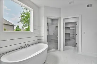 Master Bathroom with relaxing Freestanding Soaker Tub, Lap Siding, Walk In Euro Shower with Bench and 2 Shower Heads and Huge Master Closet. Picture is of Actual Home.