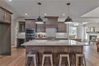 Gourmet Kitchen with Quartz Counter Tops, Stainless Steel Appliances, Custom Stain and Super Single Stainless Steel Sink. Picture is of Actual Home.