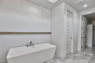 PICTURES ARE OF THE ACTUAL HOME. Large soaker tub in the master bath with a nice trim accent.