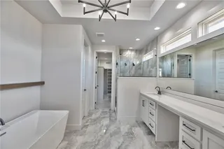 PICTURES ARE OF THE ACTUAL HOME. Gorgeous tile on the master bath floor and into the shower. Walks through to the laundry room off the master closet.