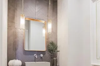 Half Bath width tile detail and elegant lighting