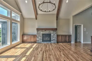 The Sonoma Reverse -  PICTURES ARE OF PREVIOUS SPEC HOME AND MY FEATURE UPGRADES - View from Entry Way into Great Room with Vaulted Beamed Ceiling, Stone Fireplace and Built-in Cabinets