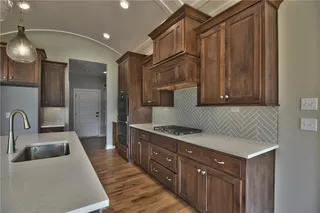 The Sonoma Reverse -  PICTURES ARE OF PREVIOUS SPEC HOME AND MY FEATURE UPGRADES - Kitchen with Barrel Vault Ceiling, Quartz Countertop and Island and Upgraded Herringbone Tile Backsplash