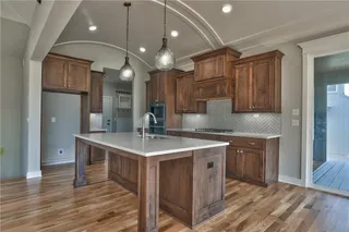 The Sonoma Reverse -  PICTURES ARE OF PREVIOUS SPEC HOME AND MY FEATURE UPGRADES - Kitchen with Barrel Vault Ceiling, Quartz Island and Countertops and Upgraded Herringbone Tile Backsplash