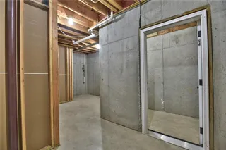 The Sonoma Reverse -  PICTURES ARE OF PREVIOUS SPEC HOME AND MY FEATURE UPGRADES - Lower Level Unfinished Storage with Storm Shelter with Steel Door
