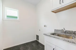 RODROCK'S CAMAS REVERSE FLOORPLAN. PHOTOS ARE OF PREVIOUS MODEL HOME, AND MAY CONTAIN UPGRADES. LAUNDRY ROOM WITH SINK.