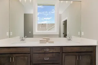 RODROCK HOMES' SAGE RANCH FLOOR PLAN. PICTURES ARE OF A PREVIOUS MODEL AND MAY CONTAIN UPGRADES. MASTER BATHROOM DOUBLE SINKS.
